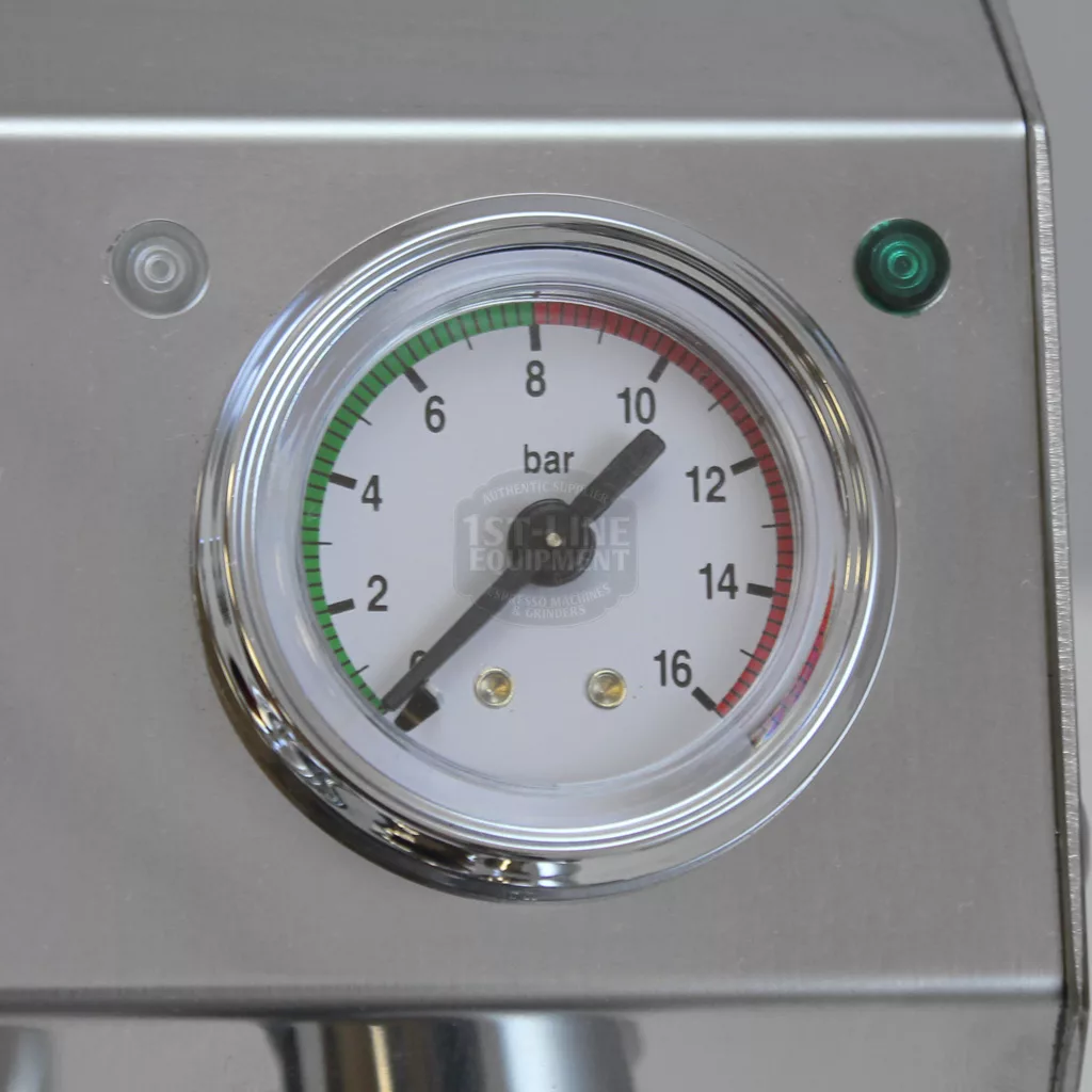 A close-up of a pressure gauge on the DISCONTINUED - VBM Domobar Junior HX Espresso Machine shows ~10 bar. The gauge has green, red, and black zones, plus a small green indicator light above—classic Domobar Junior design. © 2025 1st-line.com