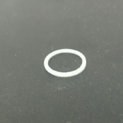 A small, white Isomac 000116 Gasket rests on a dark gray surface; it fits between the steam pipe and steam tip on Isomac TEA, Millennium, or Rituale machines. © 2025 1st-line.com