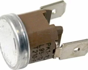 Close-up of the Isomac 000214 Coffee Thermostat 98 degree No. 14, a metal and plastic switch with two flat terminals and a round metallic top, commonly used for temperature control in appliances. © 2025 1st-line.com