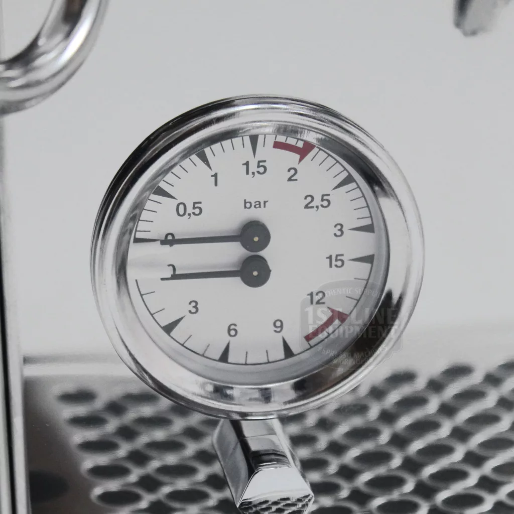 Close-up of a pressure gauge on the DISCONTINUED Bezzera BZ07 PM Espresso Machine, showing just over 1.5 bars. The metallic-rimmed gauge is mounted on a perforated metal surface. © 2025 1st-line.com