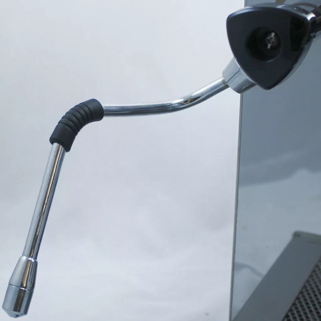 A close-up of a metal steam wand with a black rubber grip, attached to the DISCONTINUED VBM Domobar Super V4 Dual Boiler PID Switchable Espresso Machine, set against a plain light background. © 2025 1st-line.com