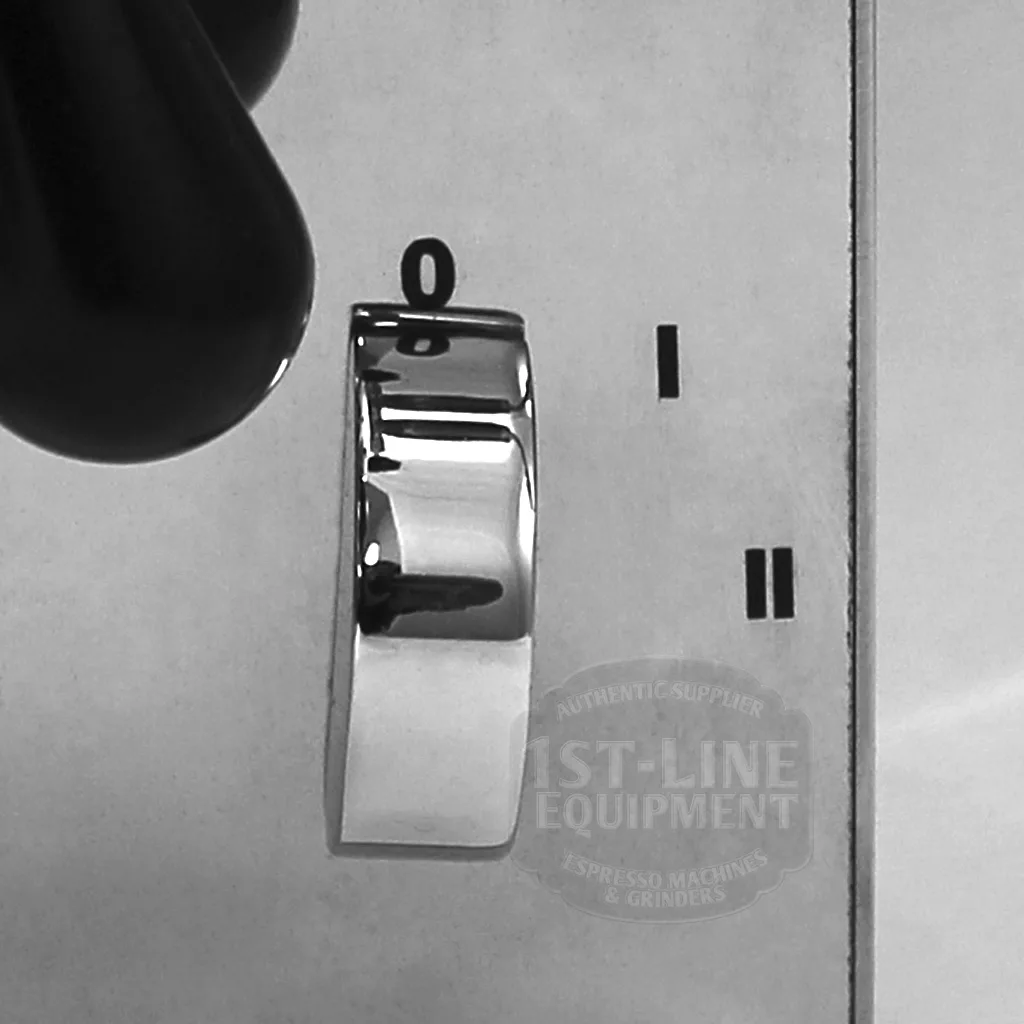 A close-up of a shiny metallic knob on the DISCONTINUED VBM Domobar Super Switchable HX Espresso Machine - Rotary Pump, set between 0 and II on a brushed metal panel, with part of a black handle in the upper left corner. © 2025 1st-line.com