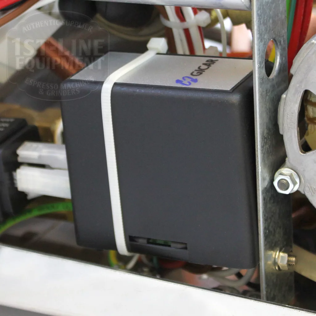 Close-up of a Gicar-branded black control box inside the DISCONTINUED VBM Domobar Super Switchable HX Espresso Machine - Rotary Pump, surrounded by metal framing, wiring, and electrical connectors. © 2025 1st-line.com