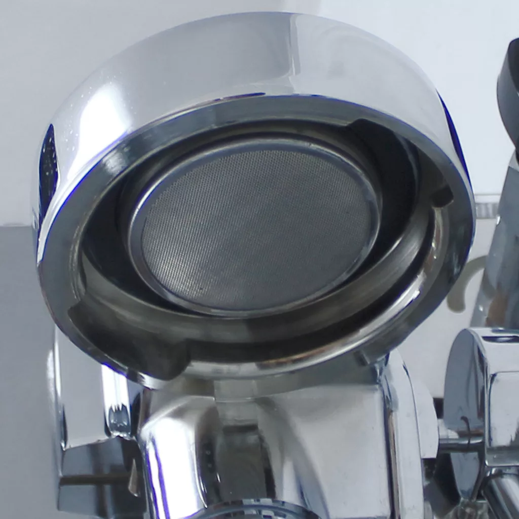 Close-up of a metallic portafilter holder with a filter basket reflecting light on the shiny chrome surface of the DISCONTINUED VBM Domobar Super V4 Dual Boiler PID Switchable Espresso Machine. © 2025 1st-line.com