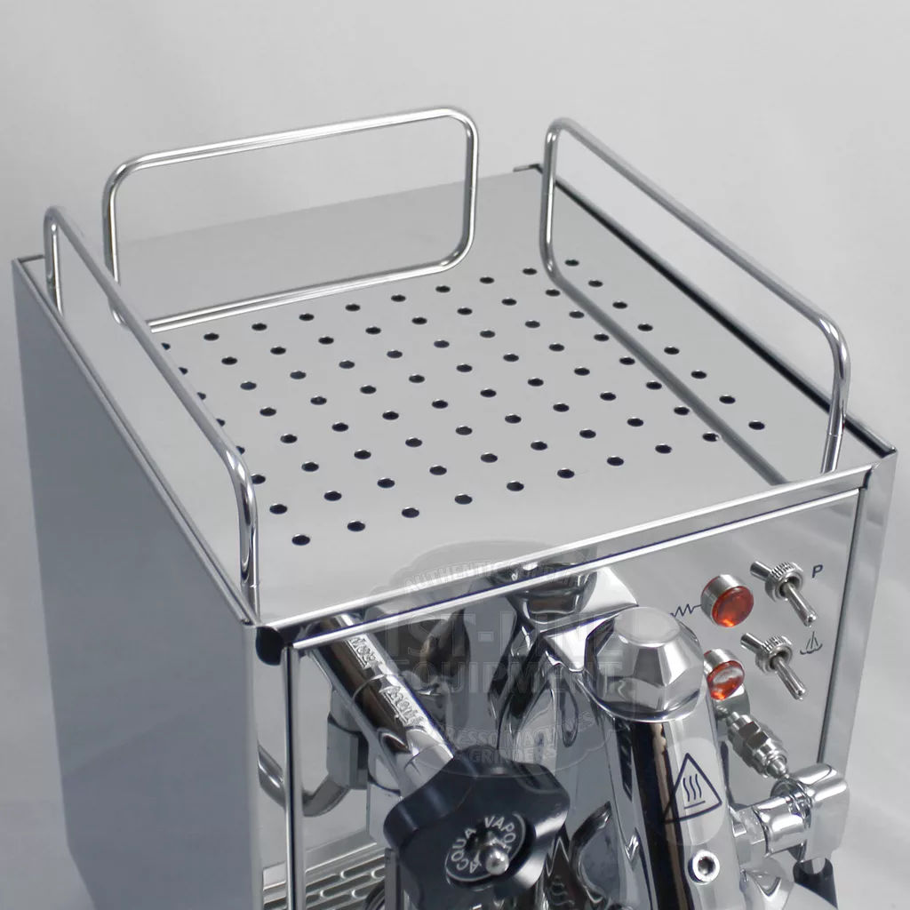 A close-up view of the top and front panel of the DISCONTINUED ECM Classika PID Espresso Machine, showing a perforated top tray with metal rails plus various side knobs, switches, and indicators. © 2025 1st-line.com