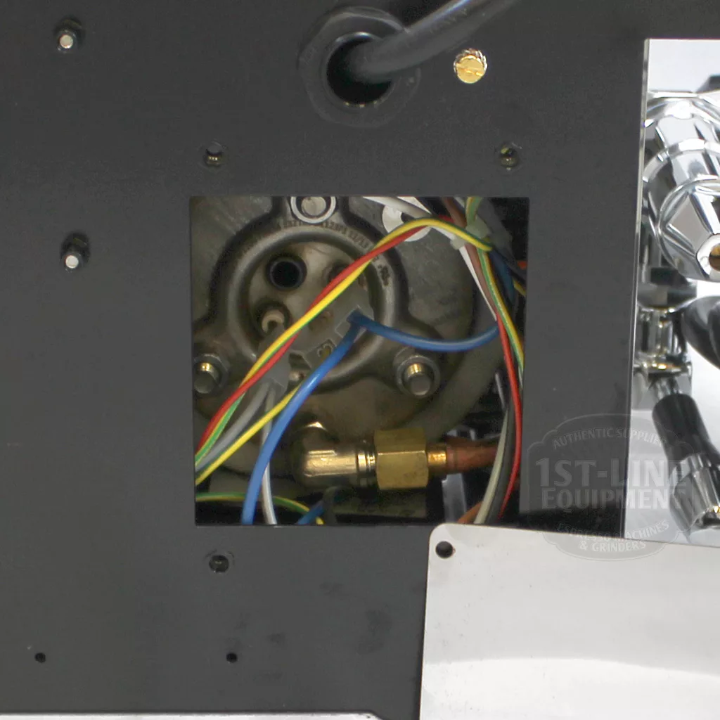 Close-up of an open panel on the discontinued ECM Classika PID Espresso Machine, showing internal wiring, connectors, colored wires, a metal fitting, and mechanical parts within a black exterior. © 2025 1st-line.com