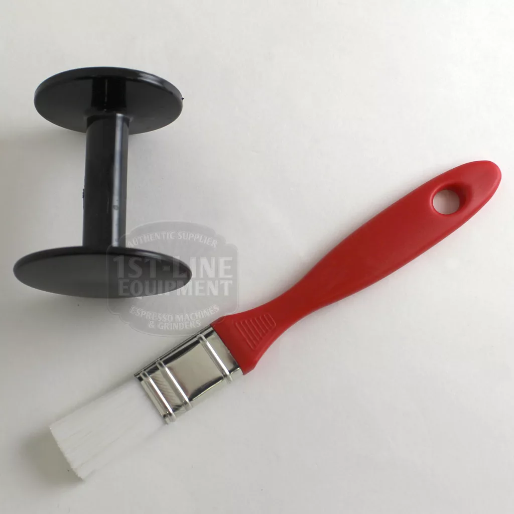 A black plastic holder for the DISCONTINUED Mazzer Mini Type A Espresso Coffee Grinder (old style) and a red-handled cleaning brush with white bristles are set on a white surface. © 2025 1st-line.com