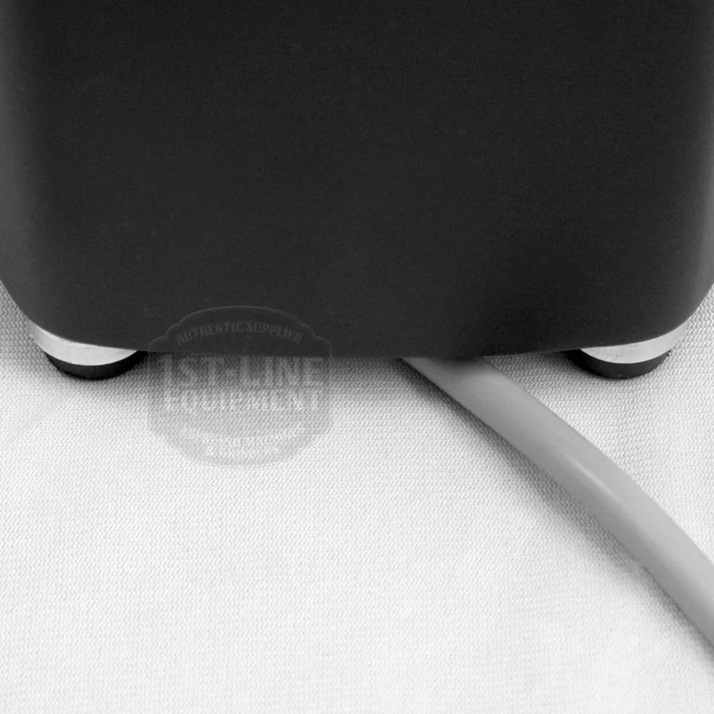 A close-up of the bottom corner of a DISCONTINUED Mazzer Mini Type A Espresso Coffee Grinder (old style), featuring small round feet and a flat gray power cord on a white textured surface. © 2025 1st-line.com