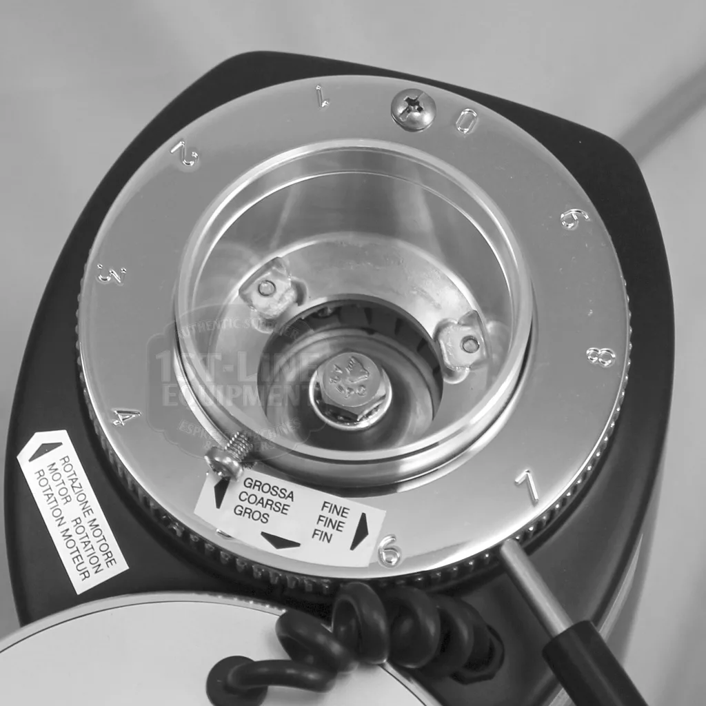 Close-up of the DISCONTINUED Mazzer Mini Type A Espresso Coffee Grinder (old style) hopper and grind setting dial, numbered 1-7 with a coarse/fine adjustment lever. Instruction labels are visible on this precise model. © 2025 1st-line.com