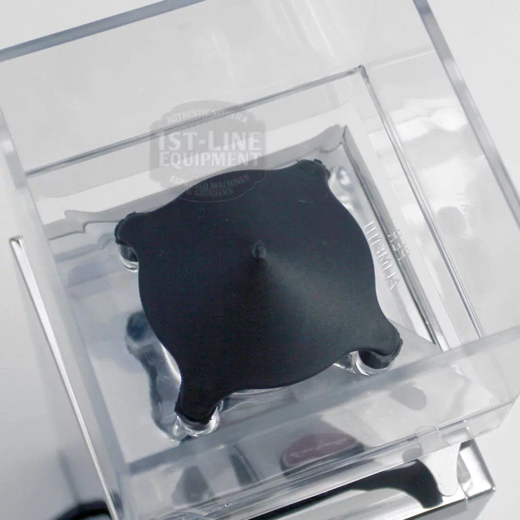 Top view of a clear Blendtec blender pitcher with a black rubber lid, featuring a raised center and corner grips—perfect beside your DISCONTINUED Eureka MCI Mignon Programmable Doserless Espresso Coffee Grinder in chrome. © 2025 1st-line.com