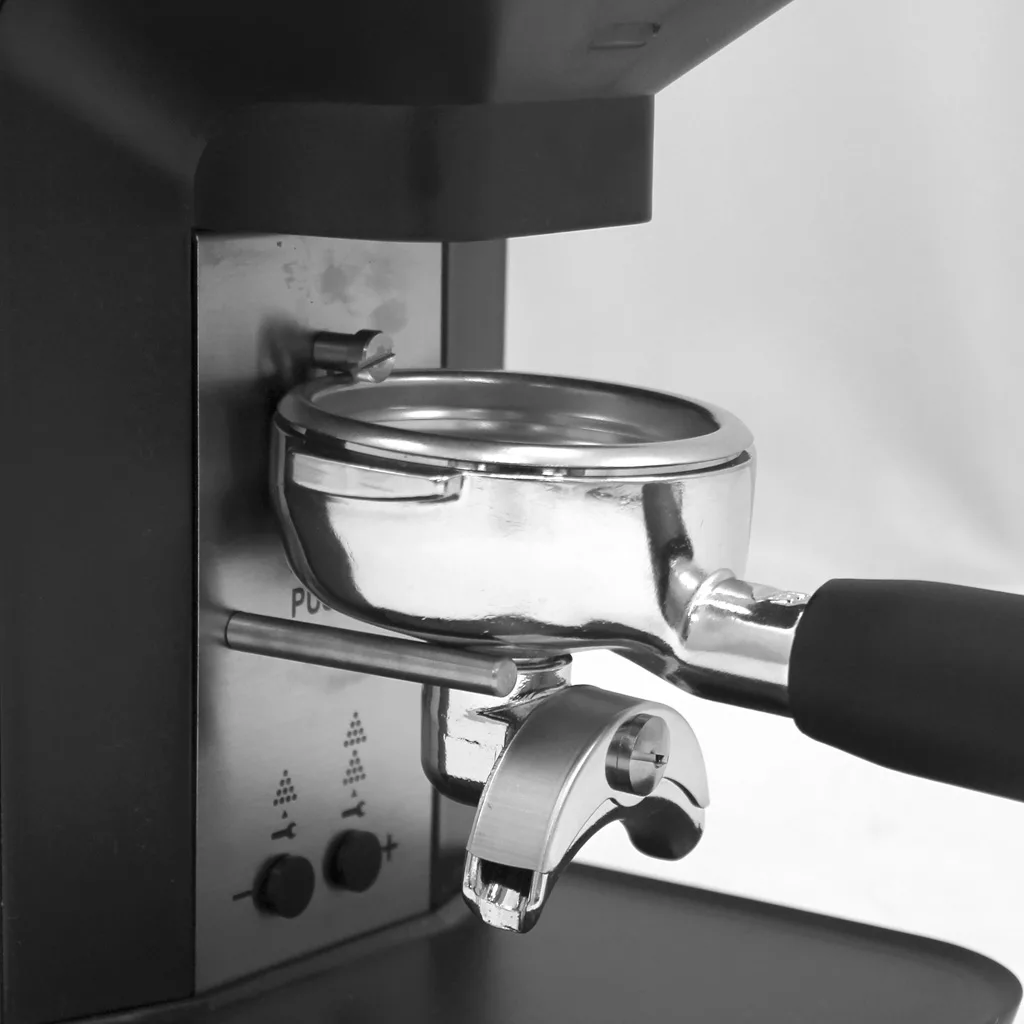 Close-up of a portafilter locked into the group head, ready for brewing, with a focus on the metallic and plastic details. Features the discontinued Lelit PL71 William Espresso Coffee Grinder in black and white. © 2025 1st-line.com