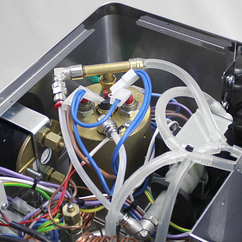 Close-up of the internal components of the DISCONTINUED Lelit PL60PLUST Diana PID Dual Boiler Espresso Machine, featuring a brass tank, tubes, pipes, wires, and connectors in a compact layout with advanced PID control. © 2025 1st-line.com