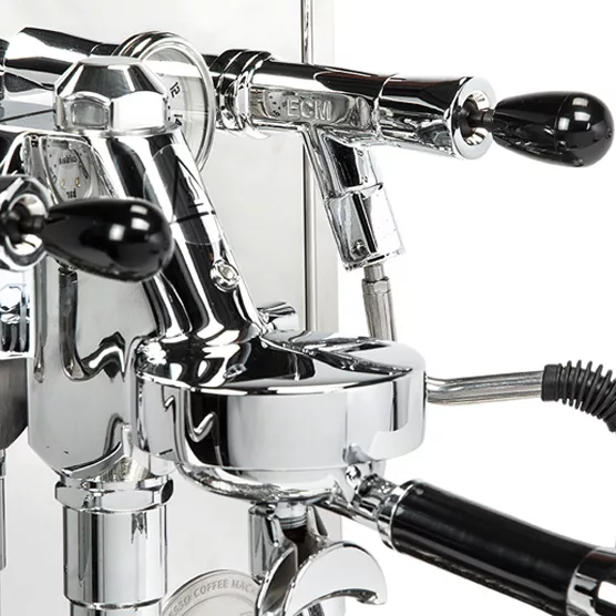 Close-up of a shiny, chrome DISCONTINUED ECM Synchronika Dual Boiler Espresso Machine - PID, Switchable with black handles and detailed levers, reflecting light and showcasing its expert craftsmanship. © 2025 1st-line.com