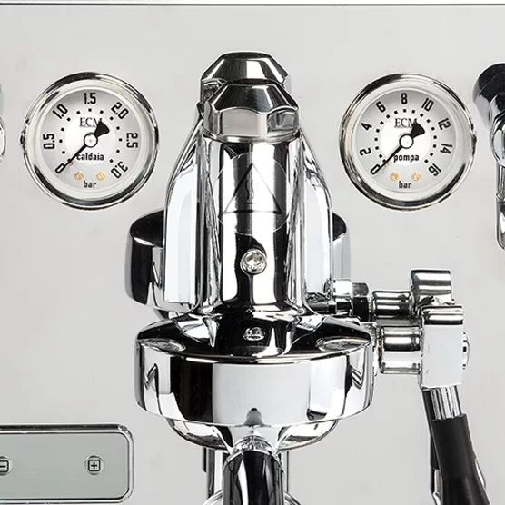 Close-up of a shiny, stainless steel DISCONTINUED ECM Synchronika Dual Boiler Espresso Machine - PID, Switchable with two round pressure gauges in bar, various knobs, and a portafilter handle at the bottom right. © 2025 1st-line.com