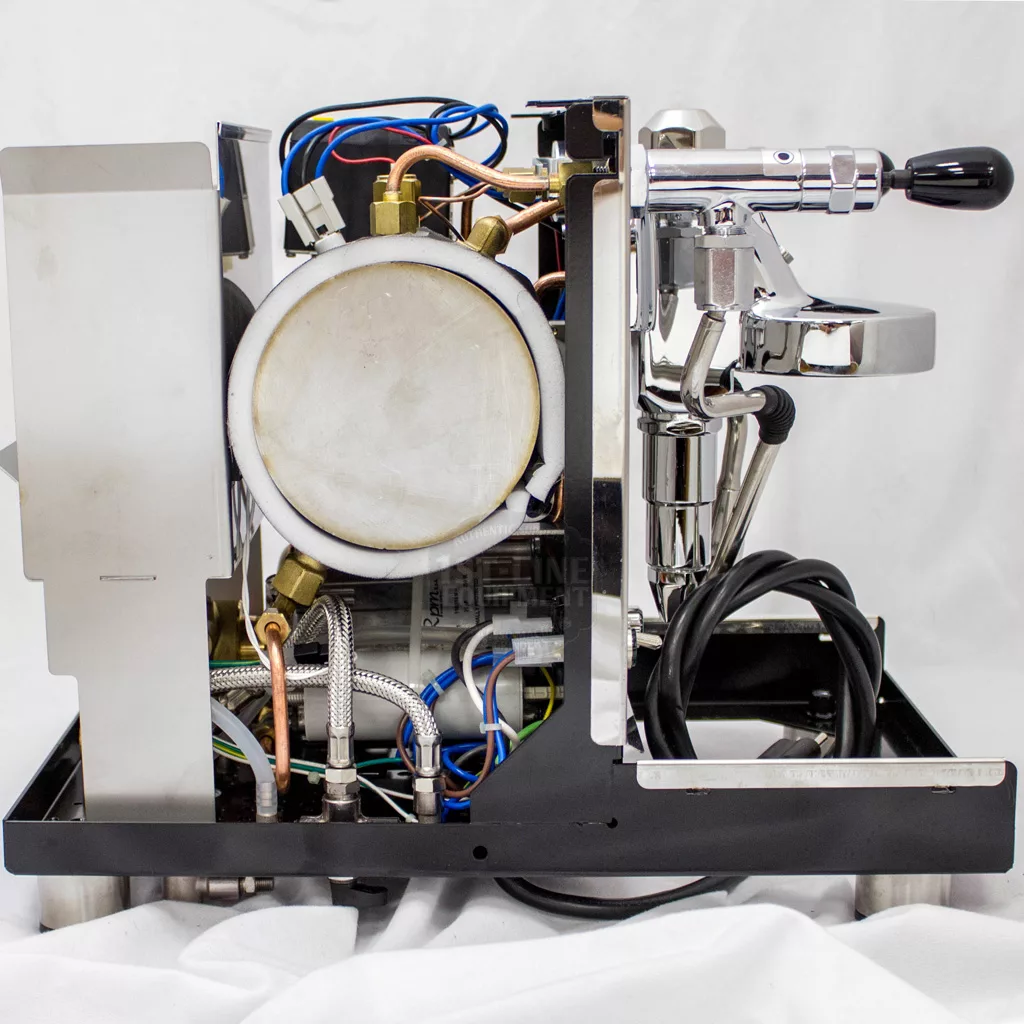 A partially disassembled DISCONTINUED ECM Mechanika Profi IV Switchable Espresso Machine exposes internal wires, a boiler, metal pipes, and the portafilter handle on the right side, all displayed against a plain white background. © 2025 1st-line.com