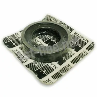 A round metal burr from the Mazzer OEM FMA00189D/AQQ 1-Phase 64mm Flat Grinding Burrs set (2 pcs) rests on black-and-white MAZZER packaging with a grid design, evoking the product’s precise engineering. © 2025 1st-line.com