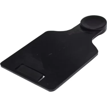 A black plastic shoehorn with a rounded handle and curved blade lies on a white background next to a Fiorenzato A3200031 Stopper For Grinder Hopper. © 2025 1st-line.com