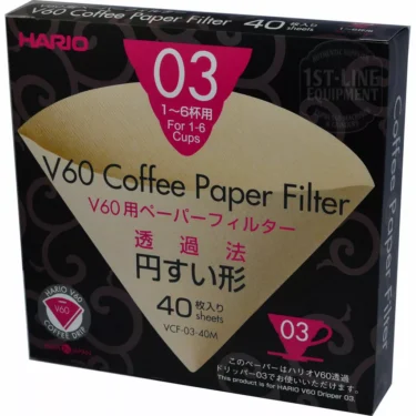 A box of Hario V60 03 Misarashi Paper Filters (40 count) for 1-6 cups in black, pink, and gold packaging with English and Japanese text plus a coffee filter image. © 2025 1st-line.com