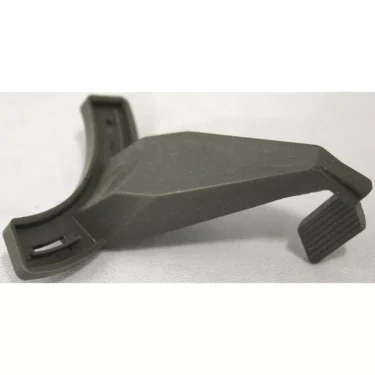 A close-up of a Saeco Lever for Grinder Adjustment on Royal/Magic Machines—black, angular plastic with a curved base and ribbed flat protrusion—rests on a light gray surface. © 2025 1st-line.com