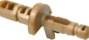 A close-up of a tan plastic drywall anchor with a flat collar and ridged shaft, similar in design to the Saeco 9161.057 Steam Valve Plastic Steamer, made for securing screws into drywall. © 2025 1st-line.com