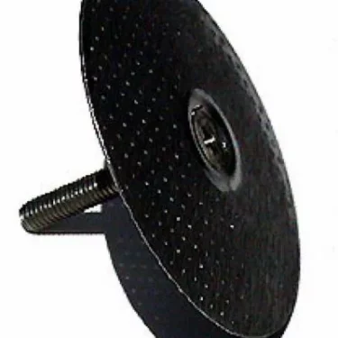 A close-up view of a round, textured, black metal disc with a central screw, similar to the Saeco Filter Screen - Upper - Magic/Royal used in coffee machines. © 2025 1st-line.com