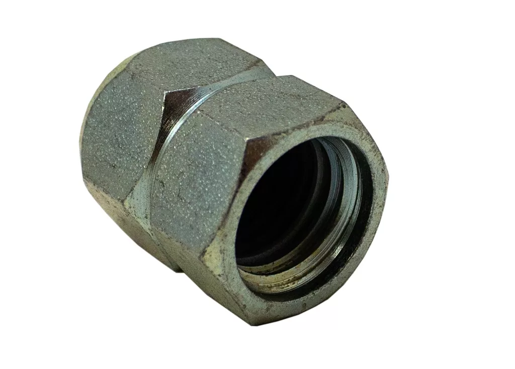 A close-up view of the Rancilio 26220015 Nut, a hexagonal pipe coupling fitting with a threaded interior and slightly worn surface, shown isolated on a white background. © 2025 1st-line.com