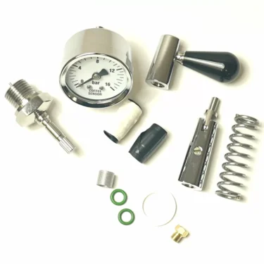A disassembled Build My VBM Espresso Bar pressure gauge kit displays the gauge dial, metal connector, spring, O-rings, and various small metal and rubber parts neatly arranged on a white background. © 2025 1st-line.com