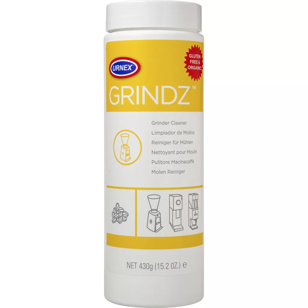 A discontinued 430g white and yellow container of DISCONTINUED Urnex Grindz Grinder Cleaner, labeled gluten-free and organic, displays illustrations for coffee grinder use. © 2025 1st-line.com