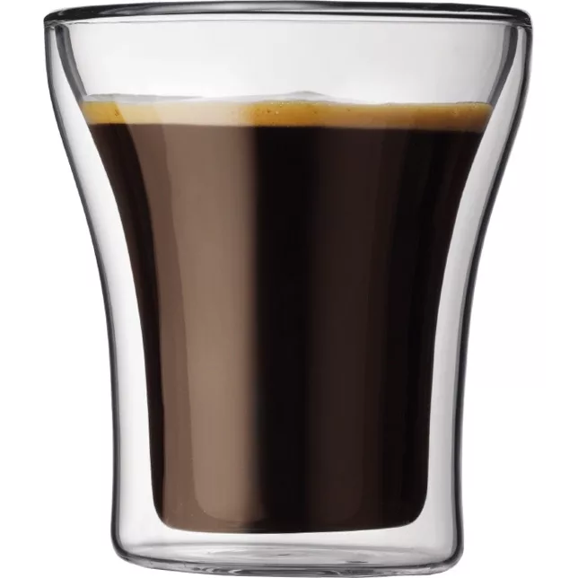 A discontinued 6.5oz Bodum ASSAM Glass with a double wall design, filled with dark espresso and crowned by crema, is isolated on a white background. Set of 2. © 2025 1st-line.com