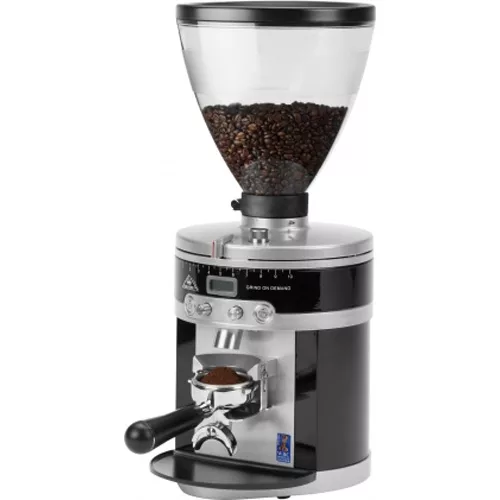 A discontinued Mahlkonig K30 Vario Espresso Coffee Grinder featuring a transparent bean hopper, digital control panel, and front-mounted portafilter holder for dispensing ground coffee. © 2025 1st-line.com