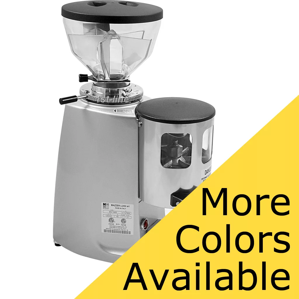 A DISCONTINUED Mazzer Mini Timer Doser Espresso Coffee Grinder in silver, featuring a transparent bean hopper and grinding chamber. Displayed on white with a yellow diagonal banner stating More Colors Available. © 2025 1st-line.com