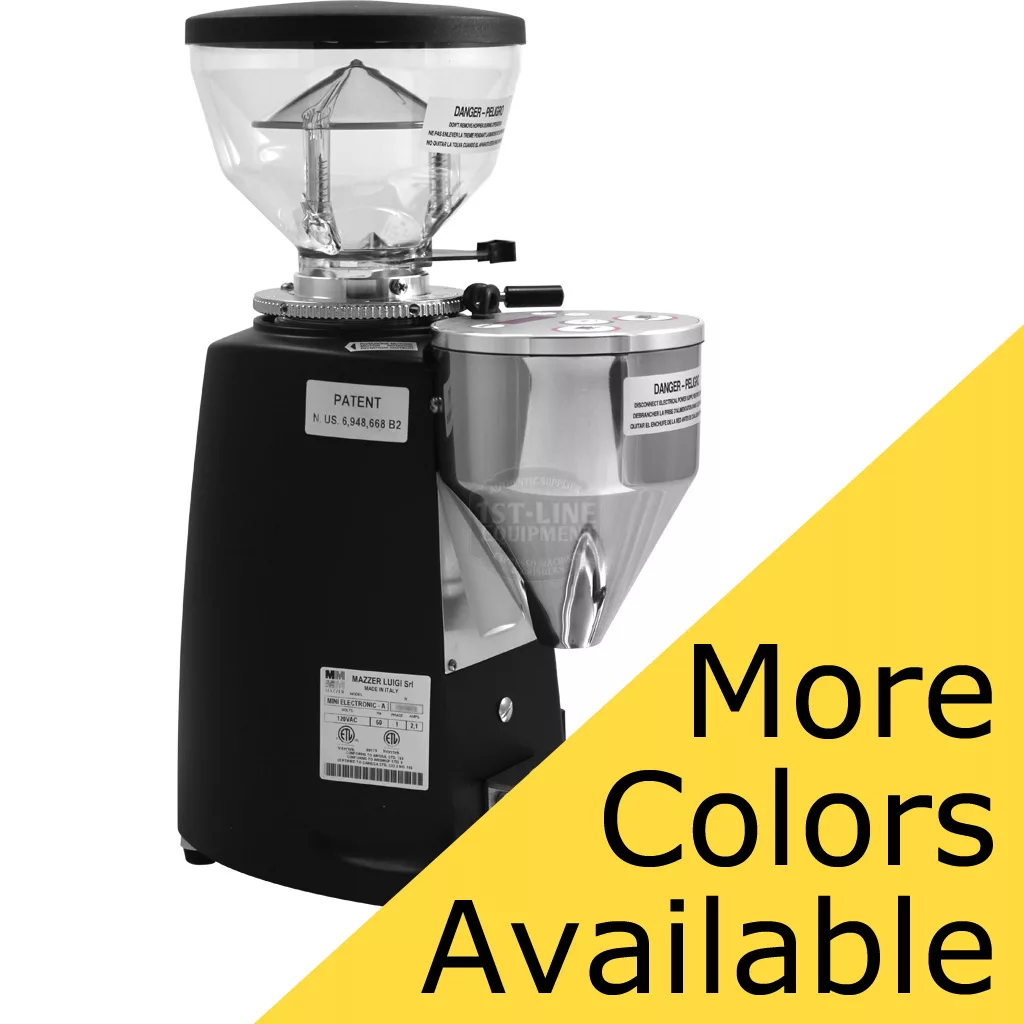 A DISCONTINUED Mazzer Mini Type A Espresso Coffee Grinder (old style) with transparent bean hopper and metal dosing chamber sits on a black base. A yellow banner reads “More Colors Available” in bold black letters. © 2025 1st-line.com