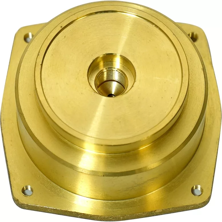 A gold-colored metal flange from the Lelit MC136 Lower Boiler Body features a circular, layered design with a central threaded hole and four mounting holes at the corners. © 2025 1st-line.com