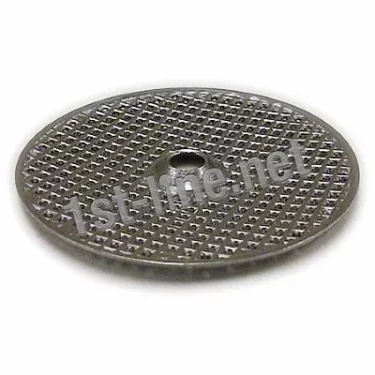 A Grimac POD Filter Screen for MiniGrimac espresso machines, made of round metal with a textured, perforated surface and central hole, is shown on a white background. 1st-line.net appears across the image. © 2025 1st-line.com