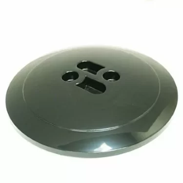 A large, dark green, round plastic button with four holes in a unique pattern resembles the Macap C0007M114 Bean Hopper Cover when viewed against a plain white background. © 2025 1st-line.com