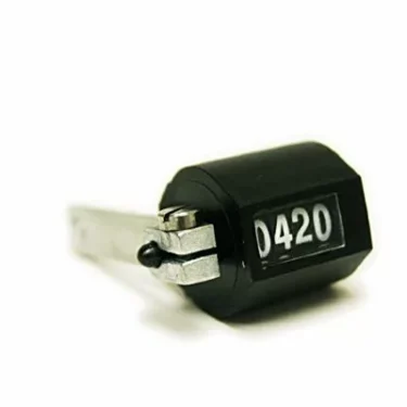 A Macap C0009M102 Timer Clicker Counter in black, displaying 0420, with a metal lever and small counting button, is set against a white background. © 2025 1st-line.com