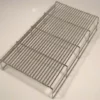 A metal cooling rack with parallel wires and four raised legs, similar to the Fiorenzato A1800176 Grid for Drip Tray for Bricoletta/Volante Tank/Reservoir Model Only, is typically used for cooling baked goods. © 2025 1st-line.com