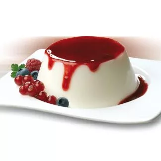 A panna cotta dessert made with DISCONTINUED Antico Eremo Panna Cotta Dessert Powder Mix - 4 x 140g bags, topped with red berry sauce, assorted berries, and a fresh herb sprig on a white plate. © 2025 1st-line.com