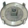 A round, silver metal part with four raised tabs, a central square hole, and two smaller circular holes, resembling the Ascaso MI.135 Lower Burr Holder for I1, I1-D, and I-Steel models. © 2025 1st-line.com