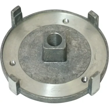 A round, silver metal part with four raised tabs, a central square hole, and two smaller circular holes, resembling the Ascaso MI.135 Lower Burr Holder for I1, I1-D, and I-Steel models. © 2025 1st-line.com