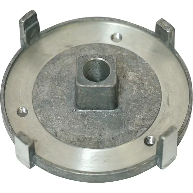 A round, silver metal part with four raised tabs, a central square hole, and two smaller circular holes, resembling the Ascaso MI.135 Lower Burr Holder for I1, I1-D, and I-Steel models. © 2025 1st-line.com
