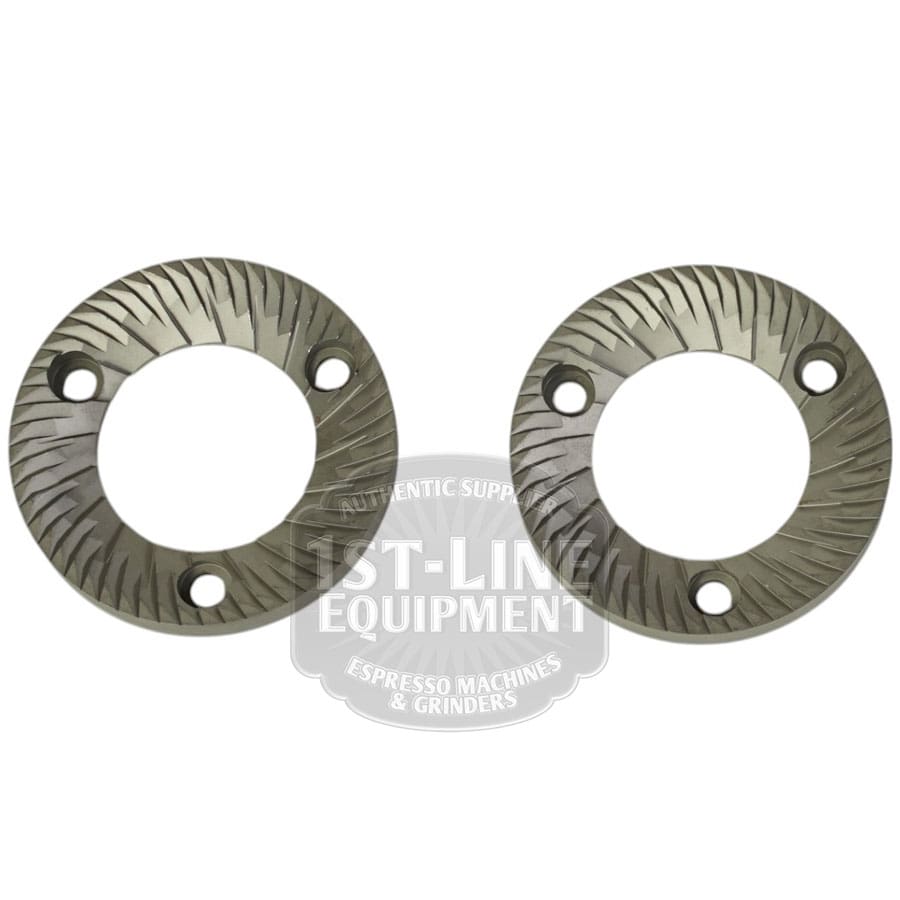 A set of two Mazzer FMA00182D/QQQ 1-phase 58mm flat grinding burrs, each with angled cutting teeth and three screw holes, displayed side by side on a white background. © 2025 1st-line.com