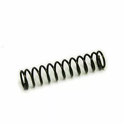 A small black metal coil spring, from the Macap M4/M5 Doser Part, lies horizontally on a plain white background. © 2025 1st-line.com