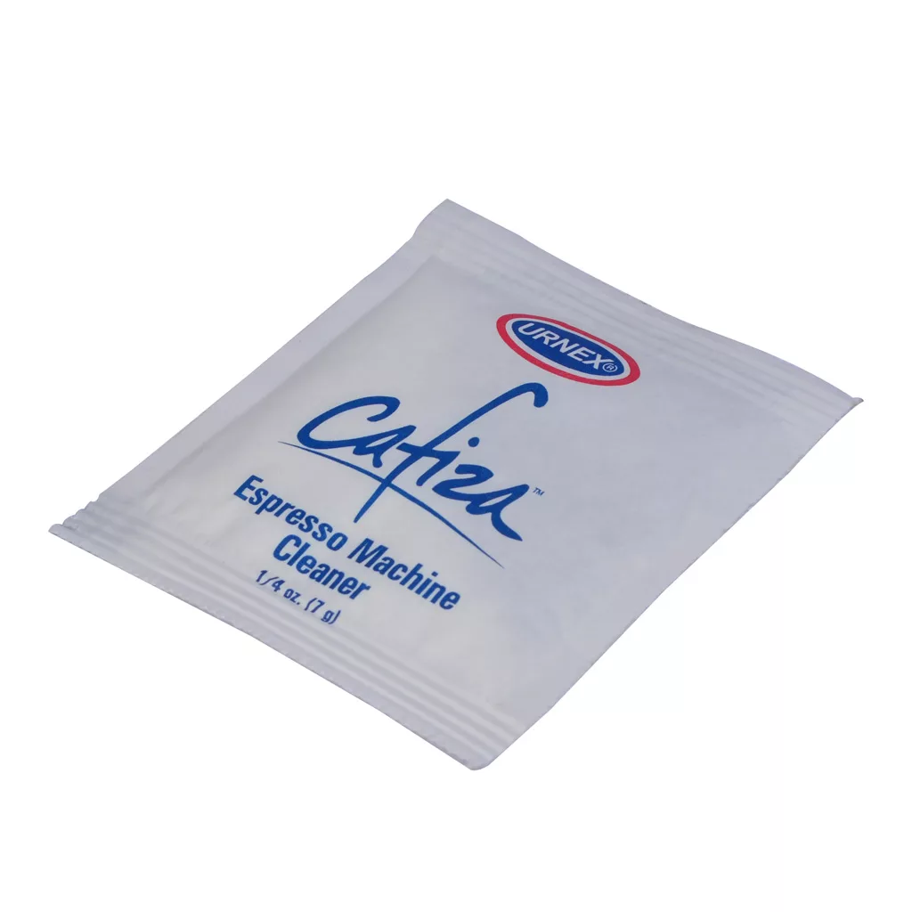 A white packet labeled Urnex Espresso Cleaner for Backflushing Sample Packet (1/4 oz, 7g), designed for cleaning and backflushing espresso machines, is shown on a plain white background. © 2025 1st-line.com