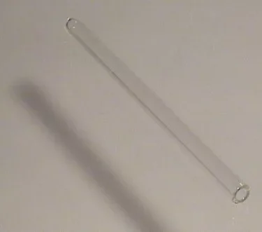 An Elektra 00141035 Water Level Gauge Glass rests horizontally on a plain, light-colored surface, casting a faint shadow to its left. © 2025 1st-line.com