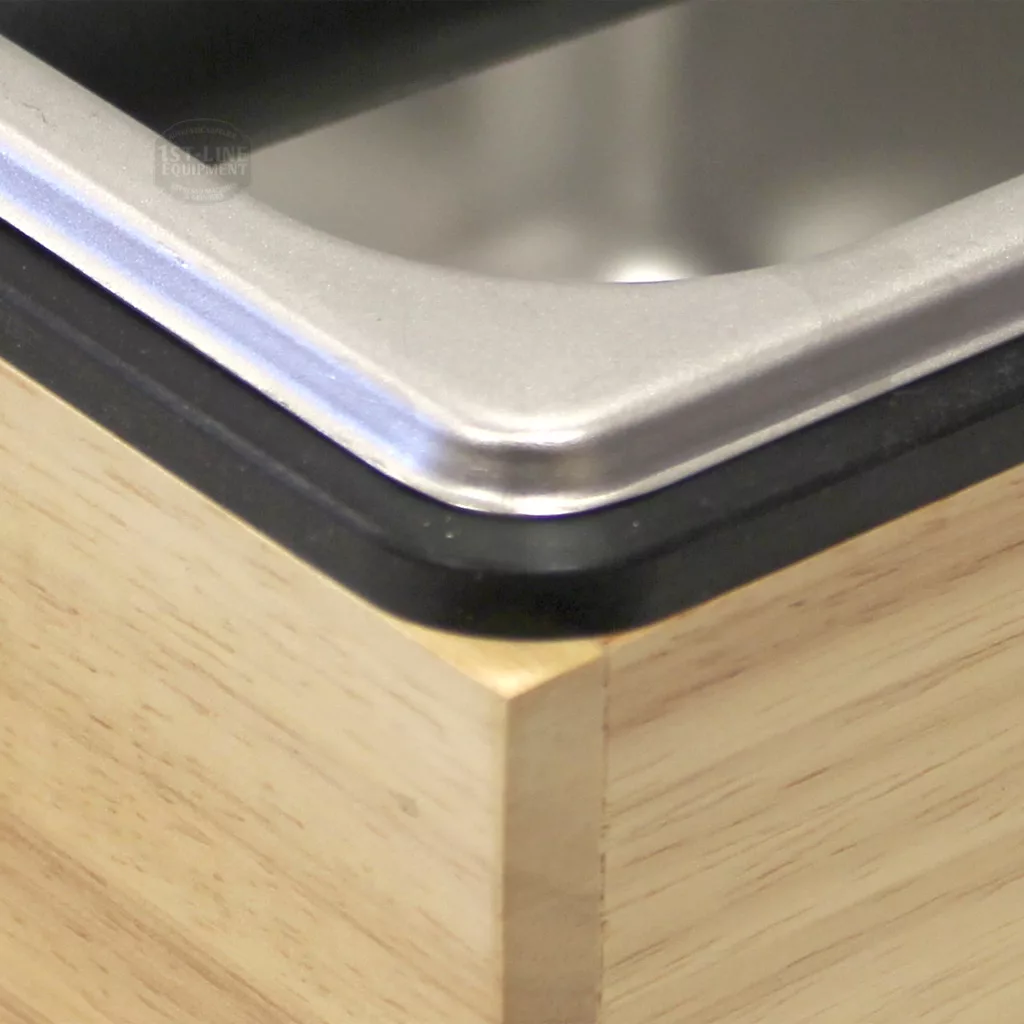 Close-up of a DISCONTINUED Revolution 25670 Basic Knock Box Set (7.5 x 7 x 4.5) metal tray, fitted into wood with a black edge lining between the tray and surface. © 2025 1st-line.com