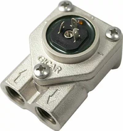 Close-up of a metallic Fiorenzato A1500026 Volumetric Counter featuring two input/output ports, arrow indicators, and exposed top electrical connectors secured by two screws. © 2025 1st-line.com