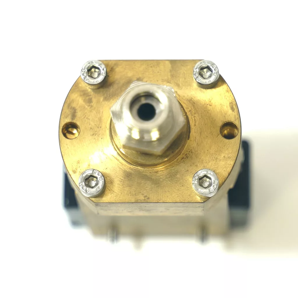 Close-up of an OEM Olympia Pressurstat brass valve with a central threaded connector and four corner screws, photographed from above on a white background. Perfect for those needing authentic Olympia espresso machine parts. © 2025 1st-line.com