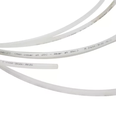 The Ascaso V..448 4x6mm Clear Inlet Hose (~1 meter) and other flexible, translucent plastic tubes with printed specs are arranged diagonally on a plain white background. © 2025 1st-line.com