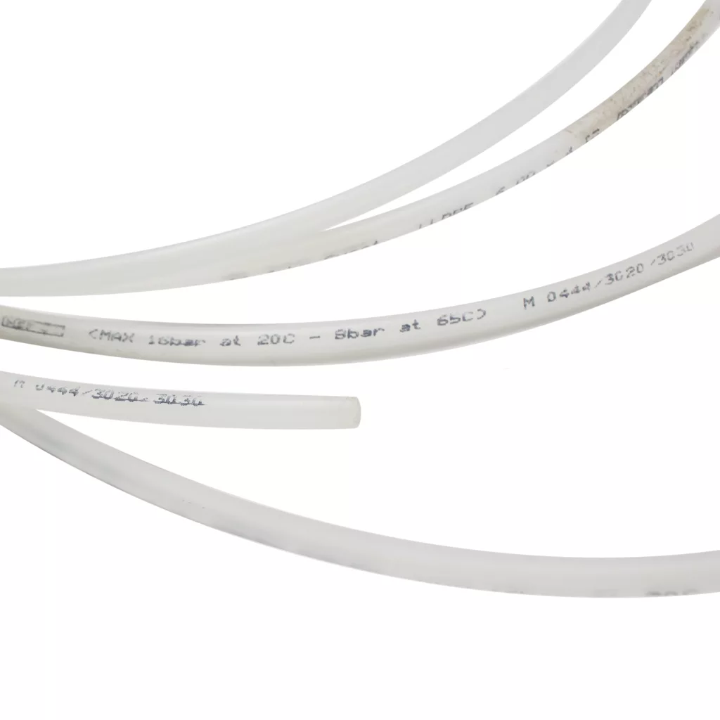 The Ascaso V..448 4x6mm Clear Inlet Hose (~1 meter) and other flexible, translucent plastic tubes with printed specs are arranged diagonally on a plain white background. © 2025 1st-line.com